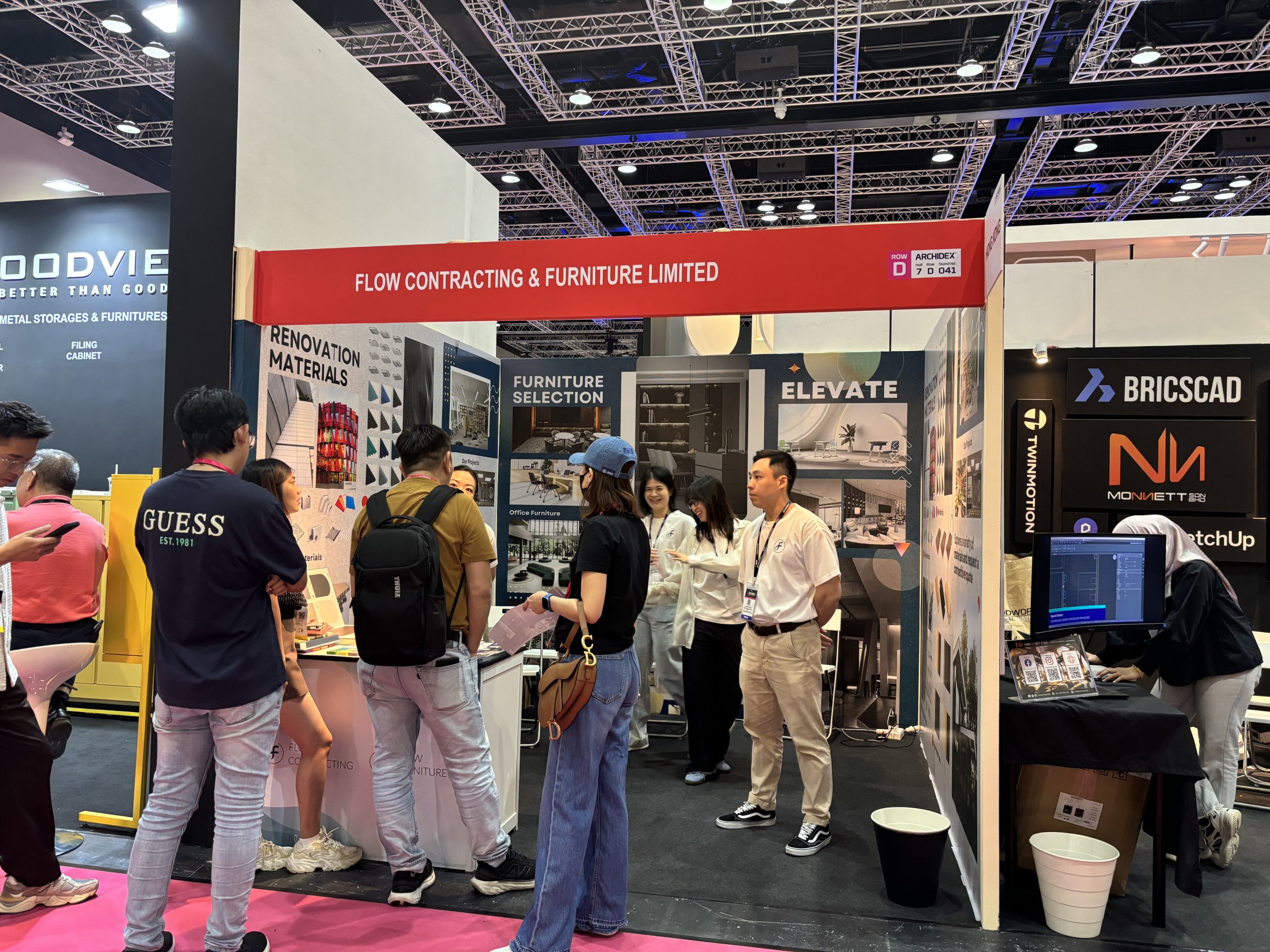 Visitors engaging with the Flow Contracting and Furniture team at ARCHIDEX